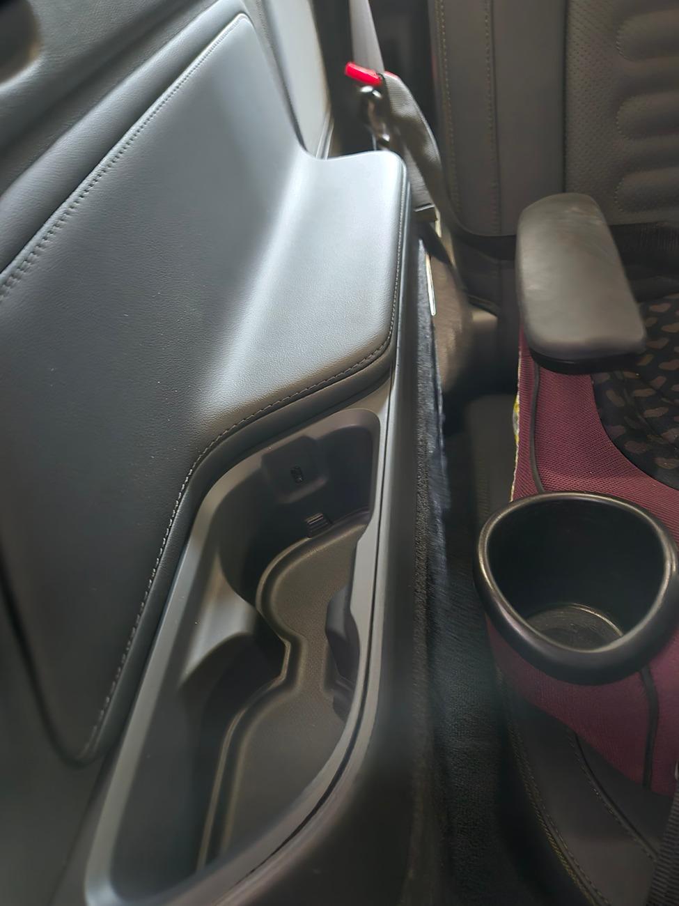 No more cubbies under armrest in 3rd row. Replaced by cupholders in
